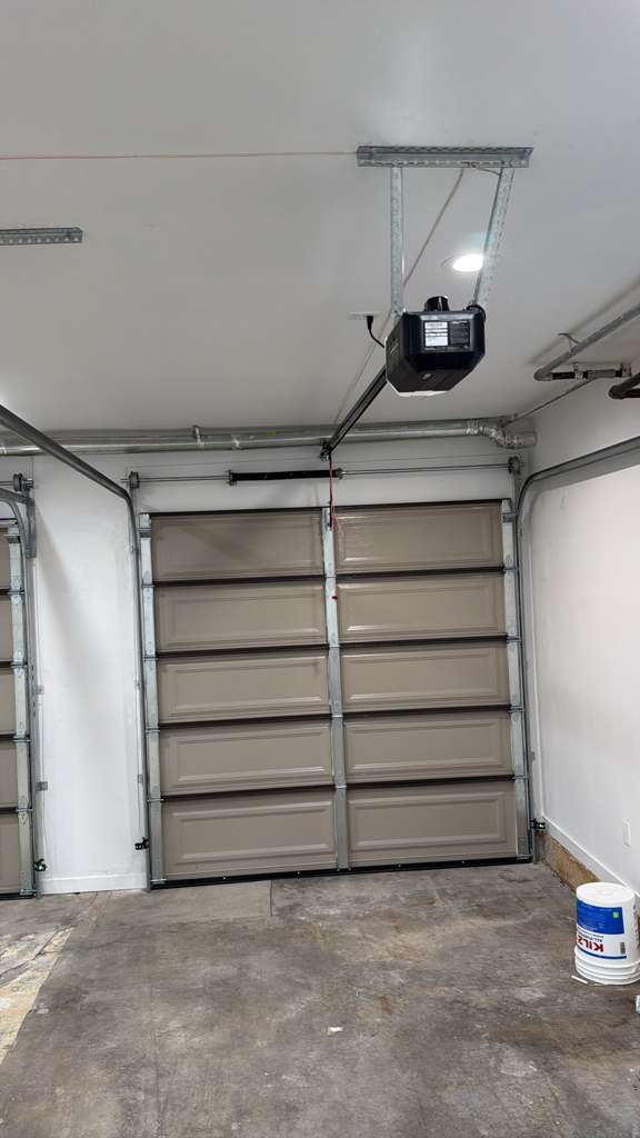 New garage door opener installed on a tan single-car garage door in a Los Angeles home